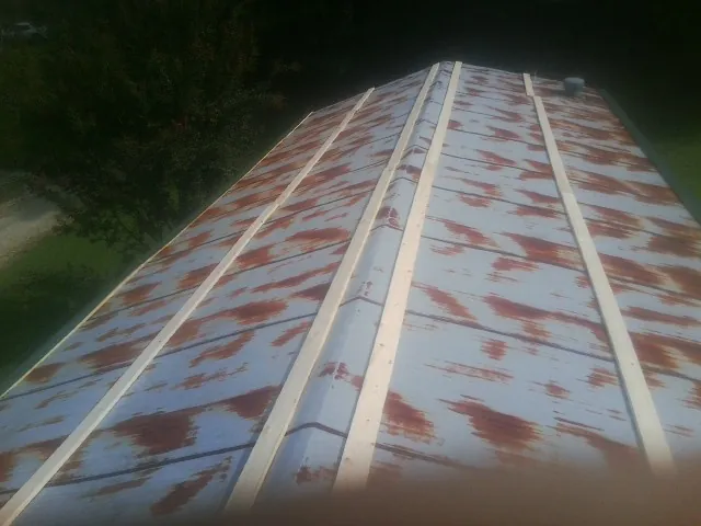 Rusted metal roof panels with new wood purlins before replacement — Storm Damage Roof Repair in Cottageville by Roofing Brothers