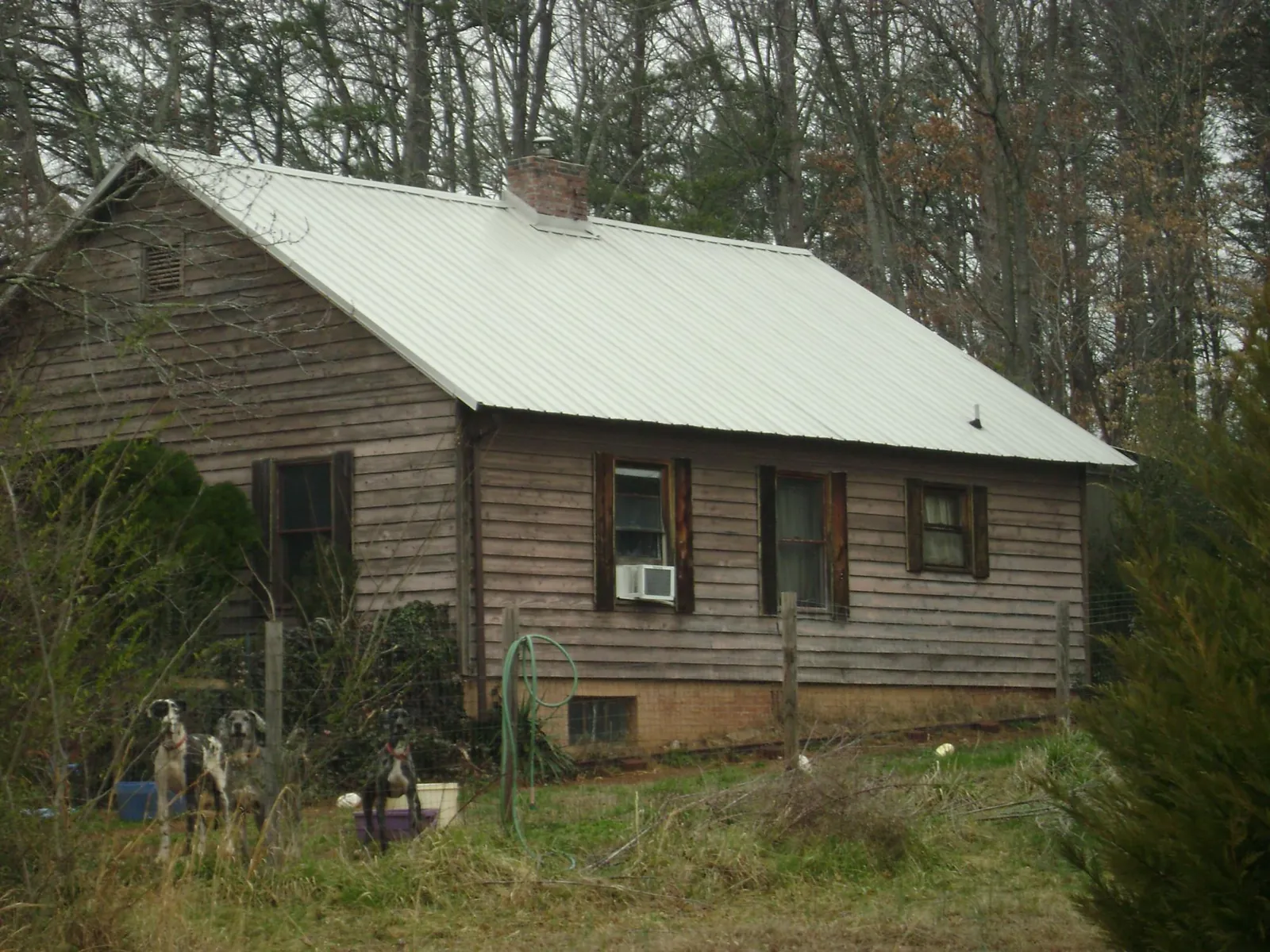 White metal roof on an old wood sided farmhouse, from a Metal Roof Installation job in Cottageville